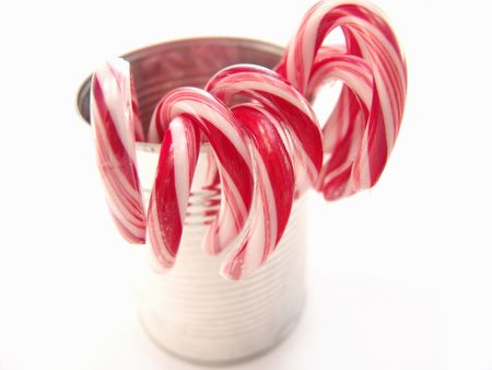stripped red and white candy canes over white backgroundの写真素材