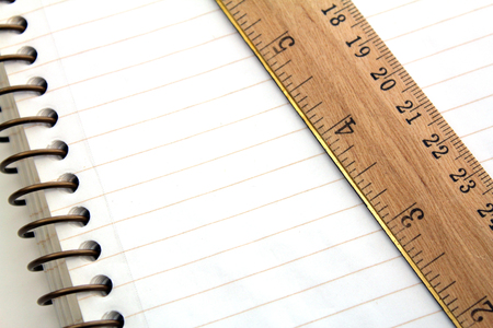 Spiral lined notebook paper with wooden rulerの写真素材
