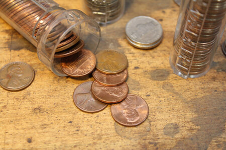 Stack of pennies in coin counter with other coins