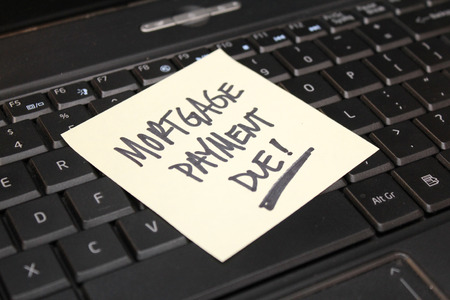 Yellow sticky note on black computer keyboard 