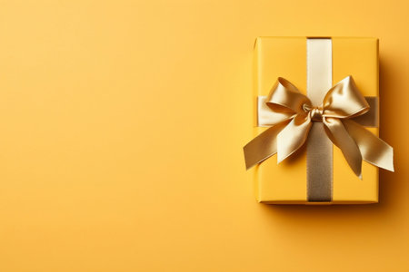 Gift Box with Golden Satin Ribbon and Bow on Yellow Generative AIの素材