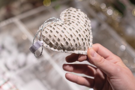 Female hands holding white plush heart. Valentine's Day. Woman's Day. March 8. Theme of love, romance.の写真素材