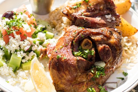 Hot and juicy roasted lamb with greek salad. Authentic Greek food.の写真素材