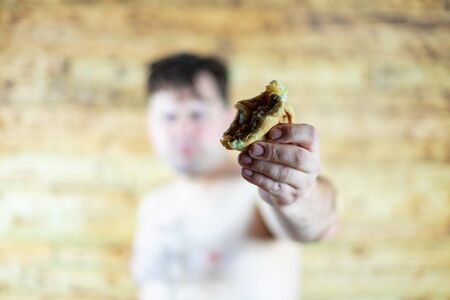 Man eating Burger. Topless man eating burger.の写真素材