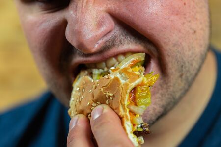 Man enjoying his tasty burger.の写真素材