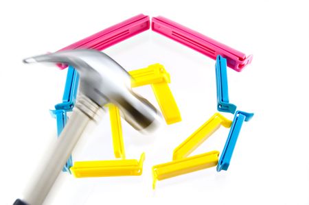 a model of a house broken by a hammer in action, photo concept about Real Estate crisisの写真素材