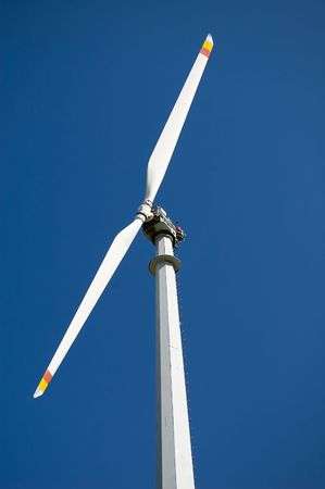 An high mountain wind turbine with blue sky backgroundの写真素材