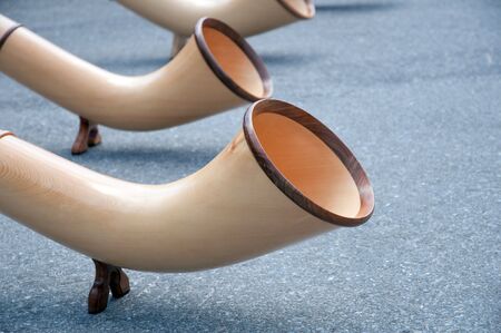 Detail of three alphorns traditional alpine wind instrumentの写真素材