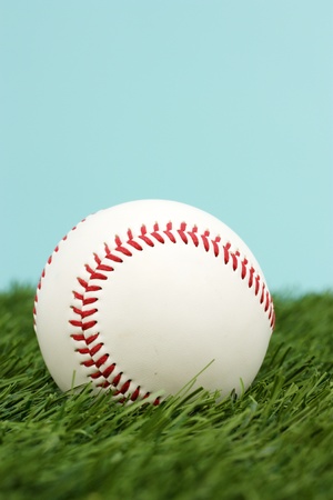 Baseball In The Green Grass With Blue Skyの写真素材