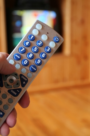 A remote control in use with a television