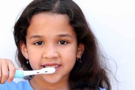 Young girl is brushing her teeth in bathroomの写真素材