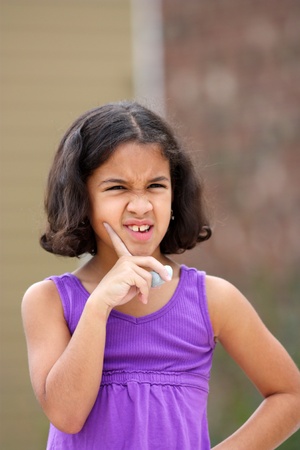 Girl in her driveway playing with chalk