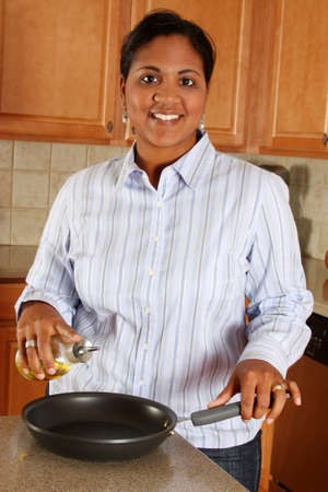 Woman cooking in the kitchen of her homeの写真素材