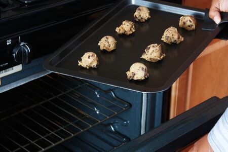 Woman standing in the kitchen of her homeの写真素材