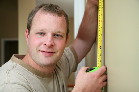 Man measuring in the kitchenの写真素材