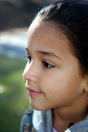 Young girl outside in jean jacket in winterの写真素材