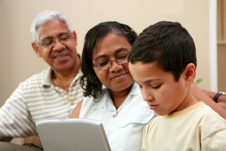 Child on computer with his grandparents