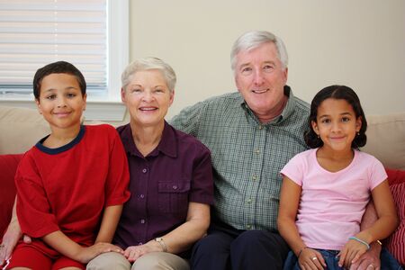 Grandparents together with their family at home