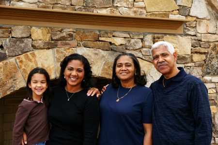 Minority family standing in their homeの写真素材