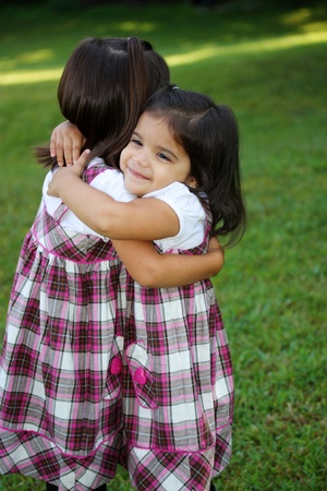 Sisters Outside Their Home In The Summerの写真素材