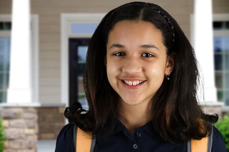 Girl with a backpack at her school