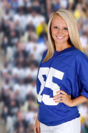 Teenage girl at a football game cheering for her teamの写真素材