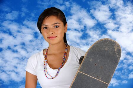 Girl skateboarding outside on a nice dayの写真素材