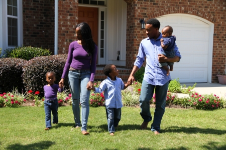 African American family together outside their home