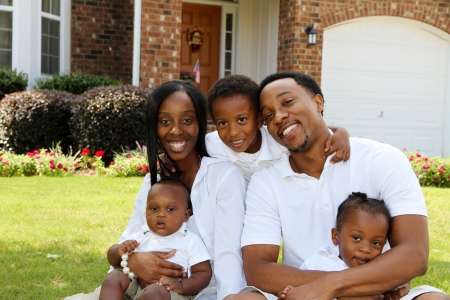 African American family together outside their homeの写真素材