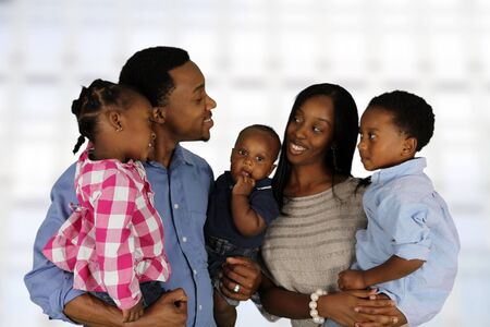 African American family together inside their homeの写真素材