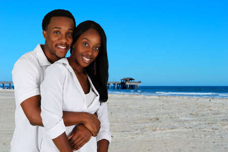 Couple standing together while they are at the beachの写真素材
