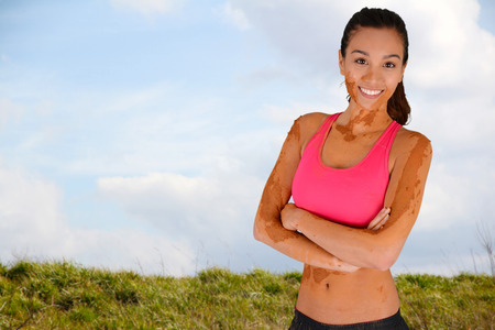 Woman competing in a mud run raceの写真素材