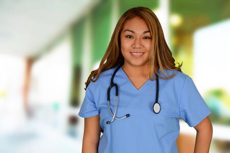 Young female doctor smiling and wearing stethoscopeの写真素材