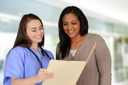 Nurse showing test results to a patientの写真素材
