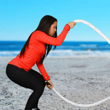 Woman who is exercising at the beach