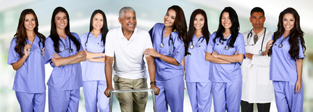 Group of doctors and nurses set in a hospital with a patientの写真素材