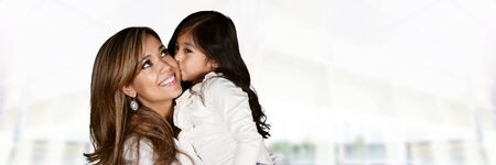Happy young woman who is standing with her daughterの写真素材