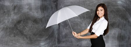 Confident businesswoman who holding an umbrellaの写真素材