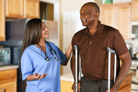 Health care worker helping an elderly patientの写真素材