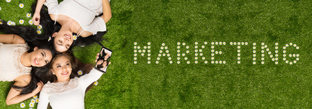 Group of teen hispanic girls laying in the grassの写真素材