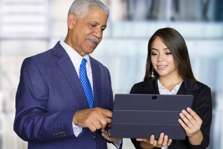 Confident businesswoman who is working with an elderly clientの写真素材