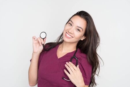 Happy female nurse posing in her scrubsの写真素材