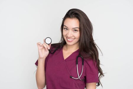 Happy female nurse posing in her scrubsの写真素材