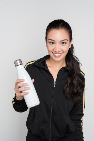 Female athlete drinking water after a workoutの写真素材