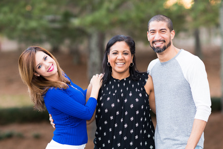 Group of three friends standing outside togetherの写真素材
