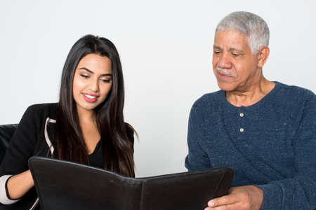 Confident businesswoman who is working with an elderly client
