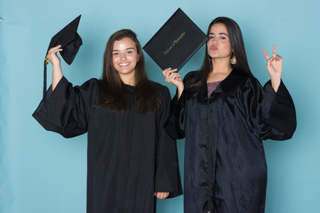 Student graduating school with a cap and gownの写真素材