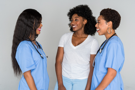 Two African American Nurses With A Patientの写真素材