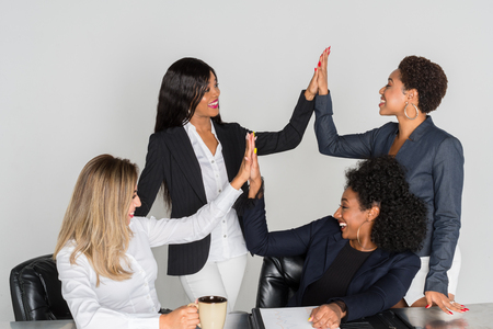 Group of businesswomen working together in an officeの写真素材