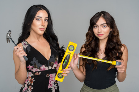 Two hispanic woman who are repairing their homesの写真素材